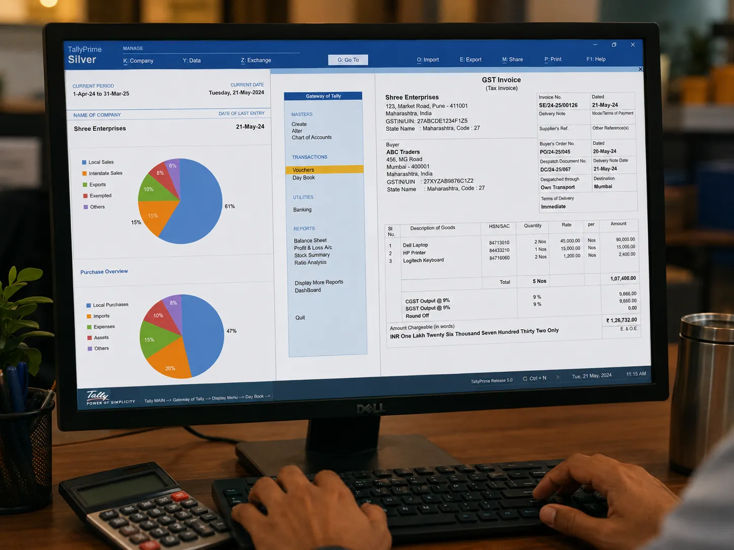 Office computer running Tally accounting software with invoices on the desk